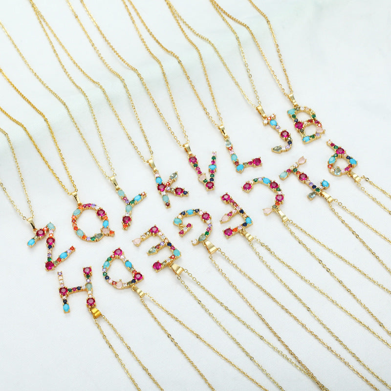 Collier avec lettres en pierres précieuses